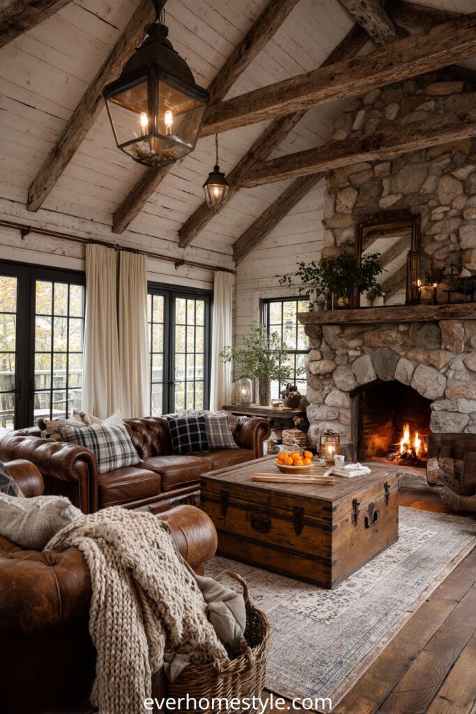 Rustic living room with stone fireplace, leather sofas, and exposed wooden beams