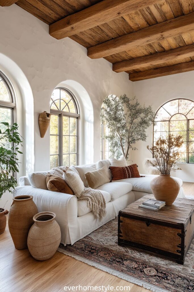 Mediterranean living room with white stucco arches and terracotta accents.